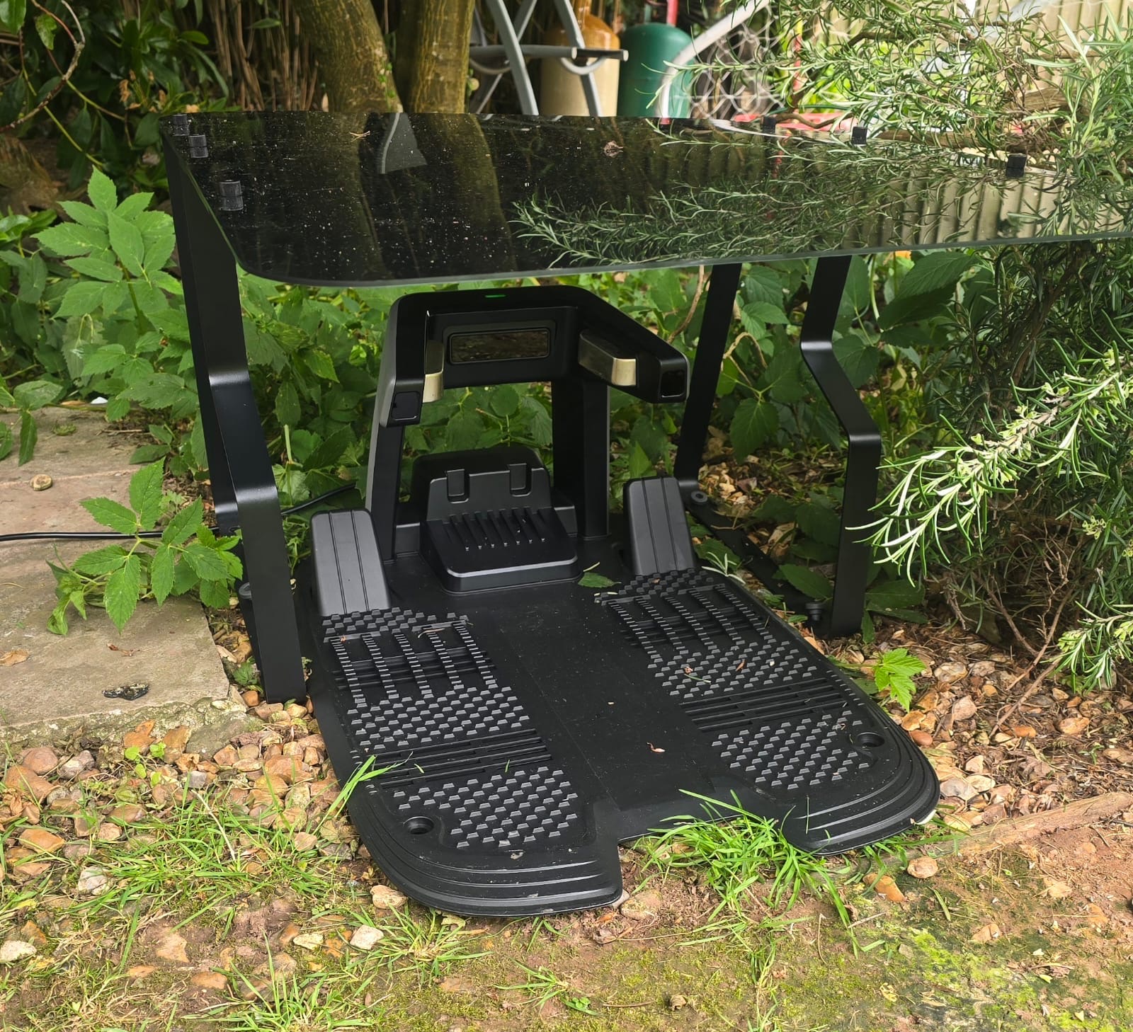 Robot mower docked at its charging station in the garden